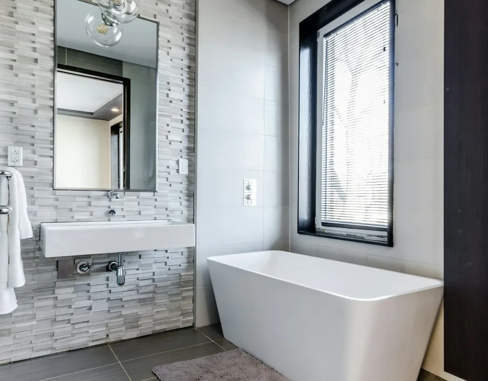 Bathtub near a window in a renovated bathroom
